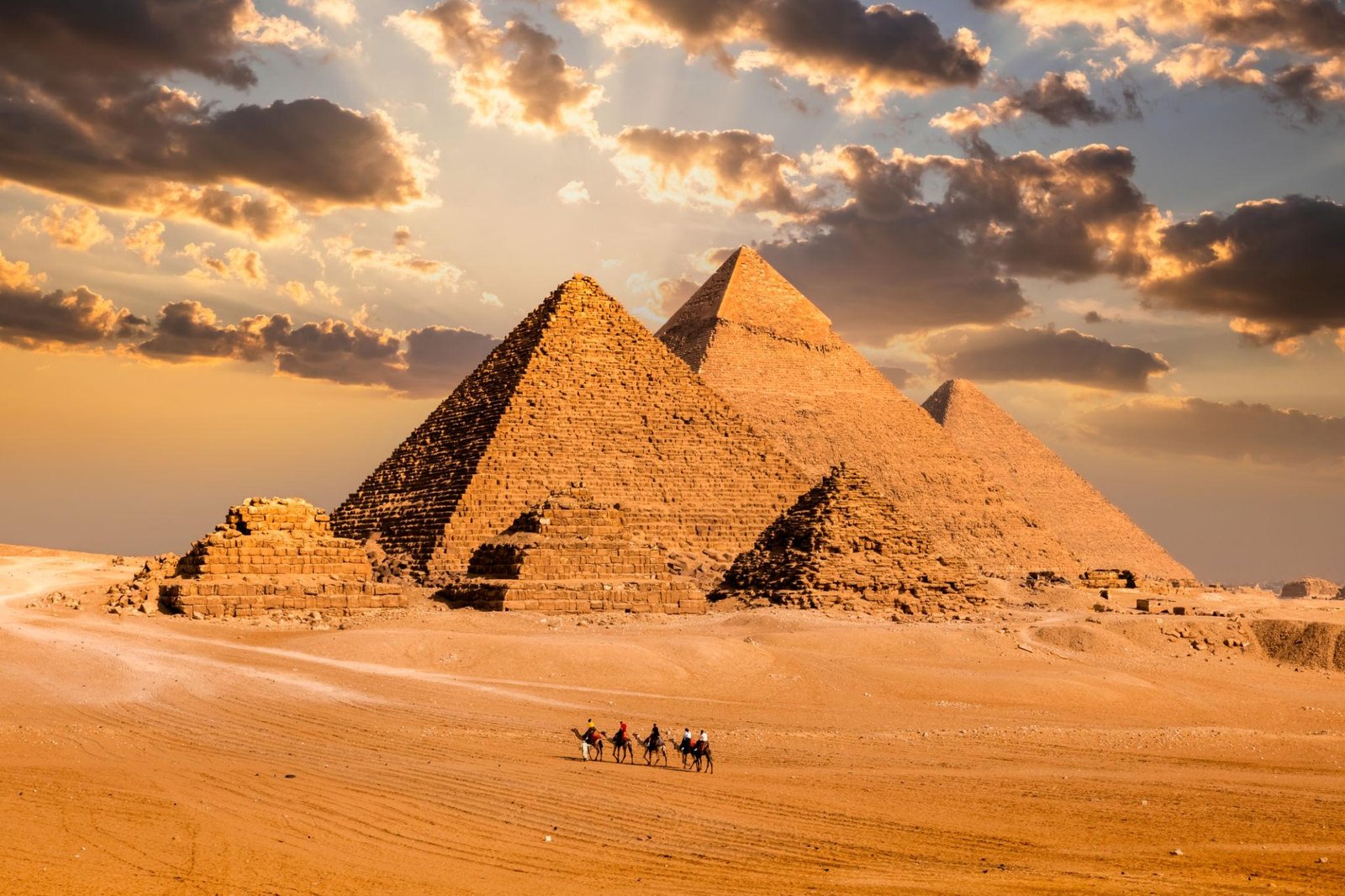 Pyramids of Giza in Egypt with desert landscape at sunset